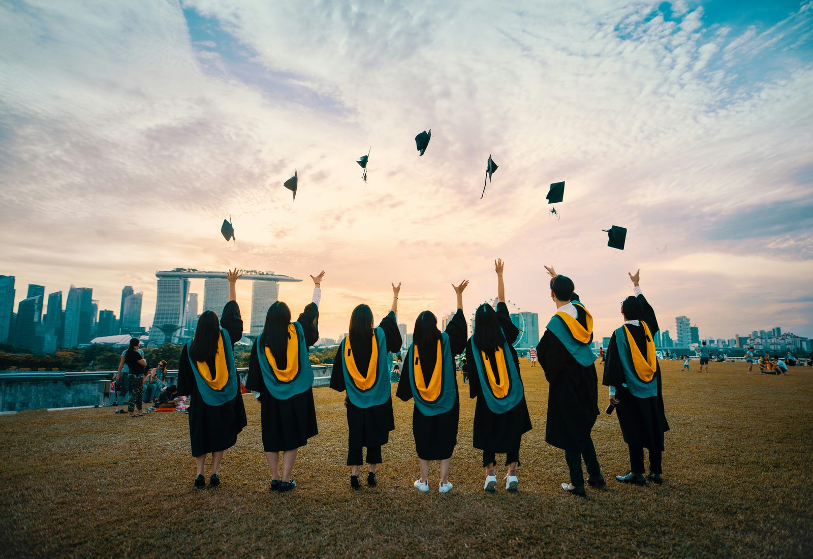 Graduates celebrating outside a university building
