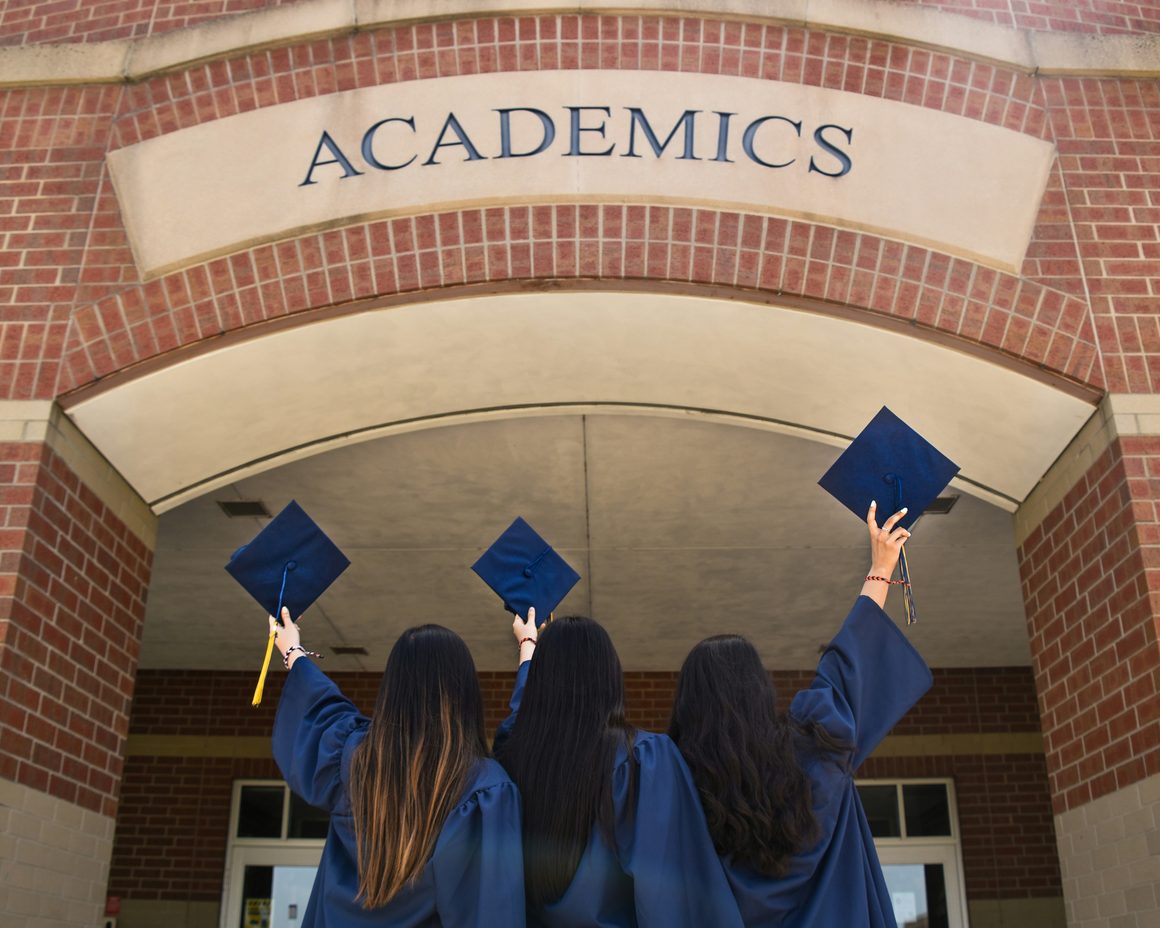 Graduates throwing their caps in the air
